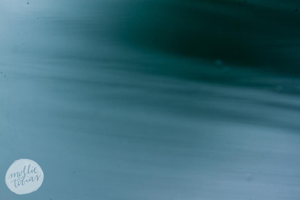 a series of blue, aqua, and green flowing abstract images