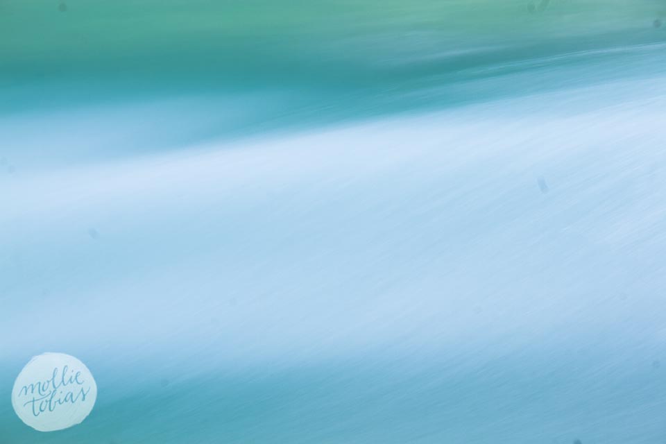 a series of blue, aqua, and green flowing abstract images