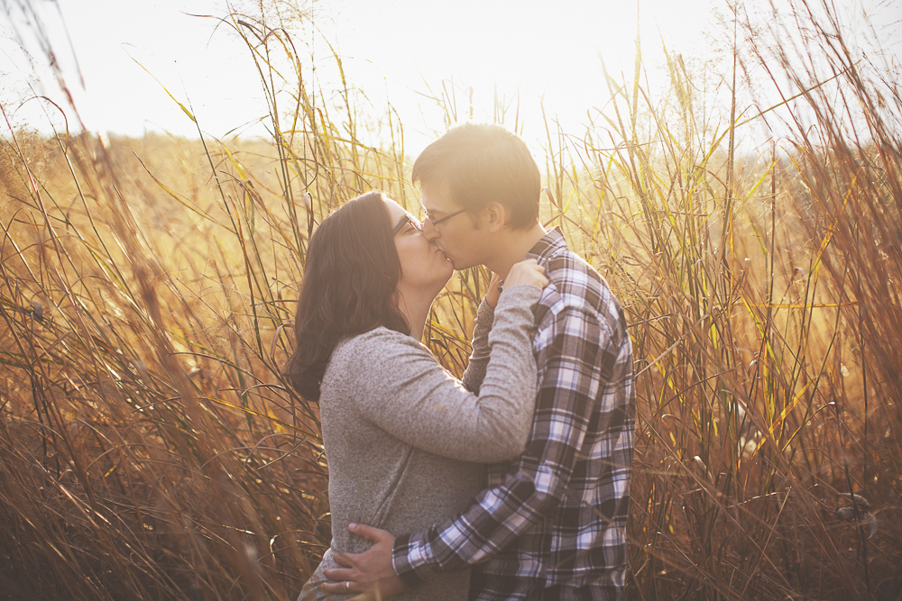couple kissing in tall grass