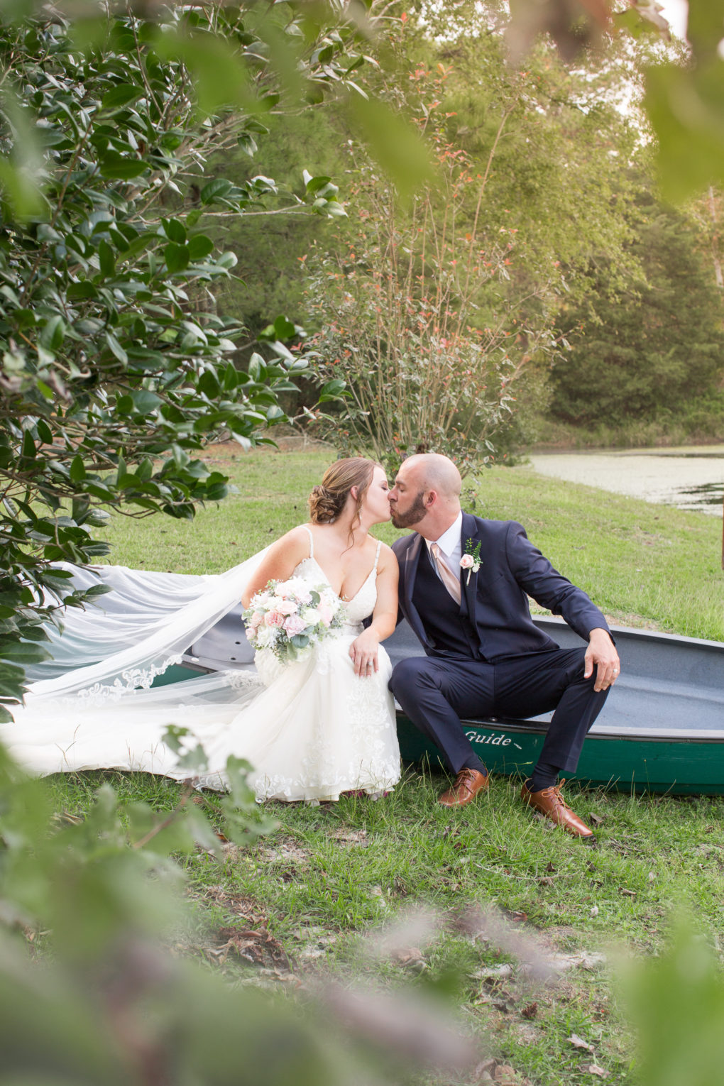 wedding couple kissing in canoe at a wedding at the Wallace