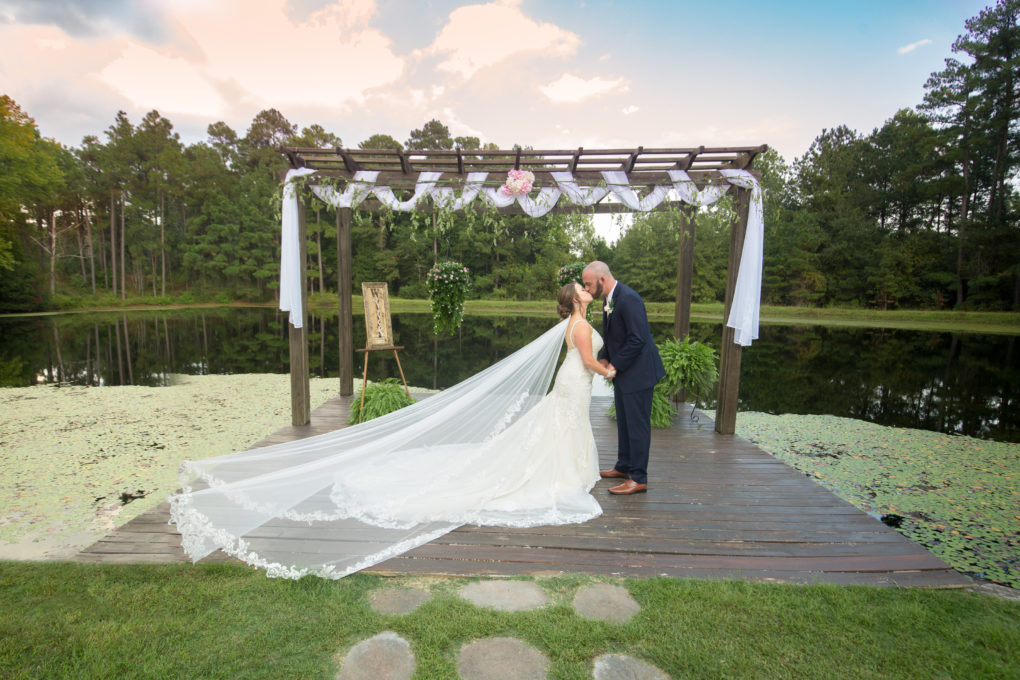 ceremony location photo at the Wallace wedding venue with pergola in front of lake