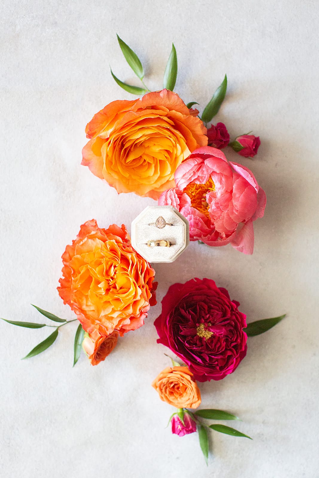 flatly of wedding rings with bright peonies and other wedding florals from a 305 Trackside wedding in Southern Pines North Carolina