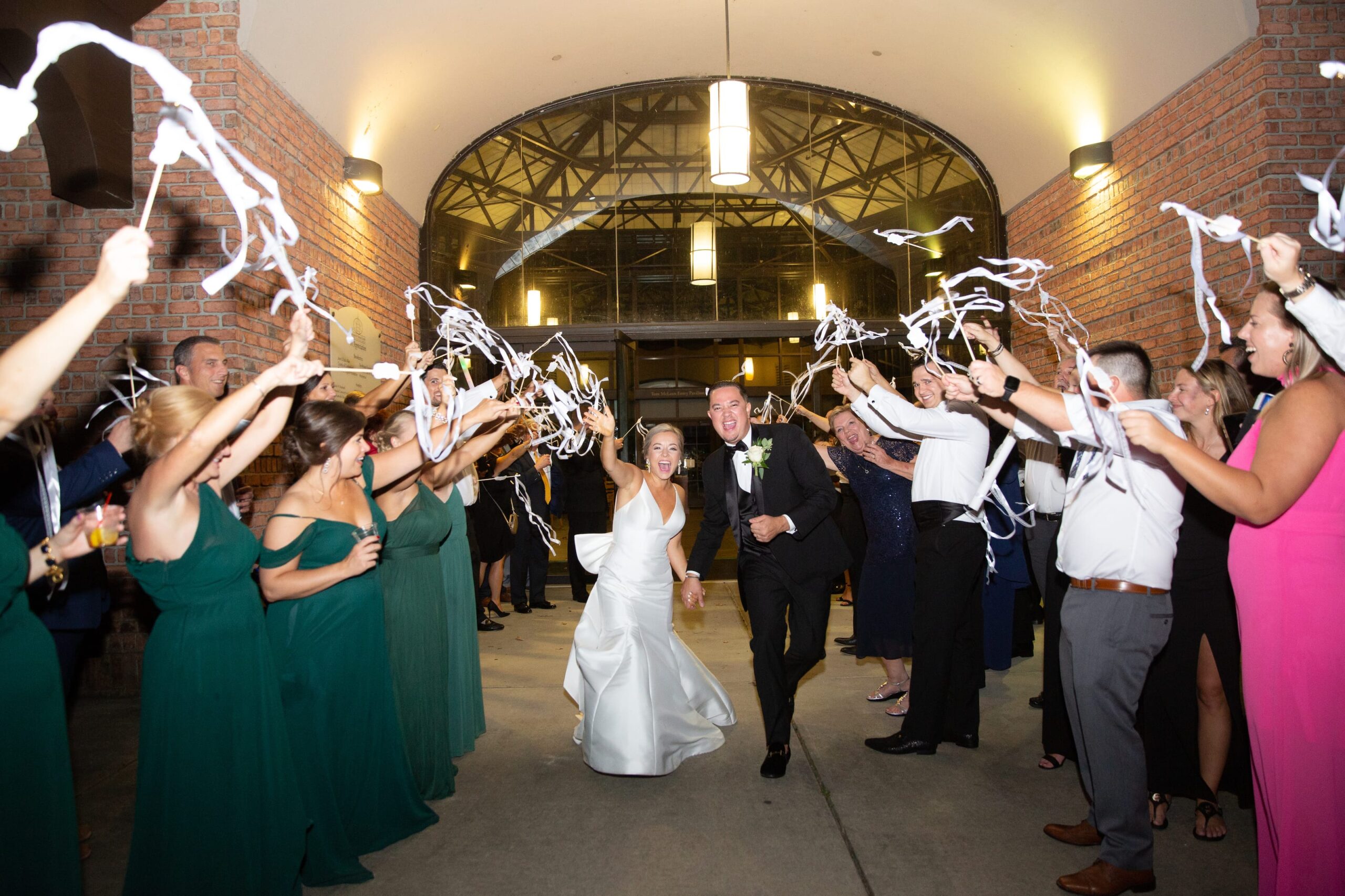 couple running through streamers for their wedding exit