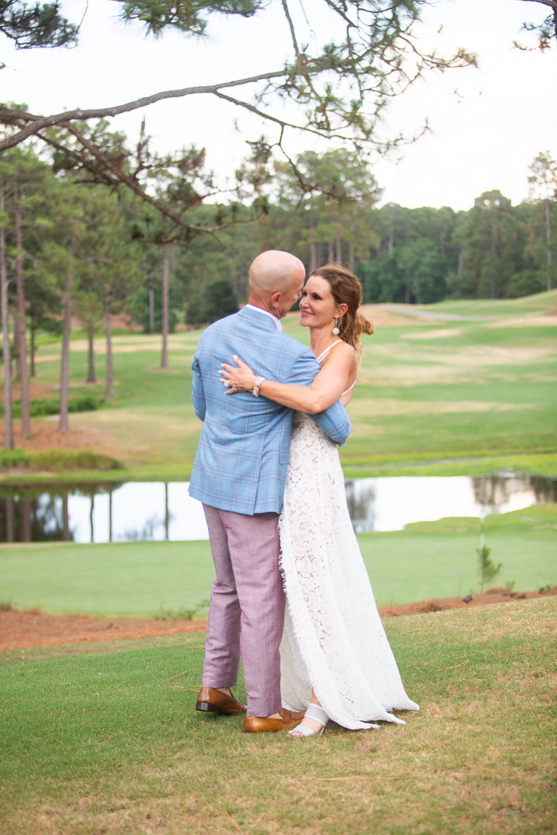 wedding couple photos overlooking the greens at Forest Creek wedding in Pinehurst