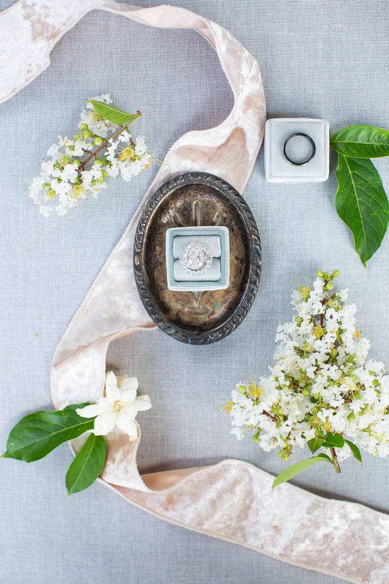 detail shot wedding rings with white flowers at Forest Creek wedding