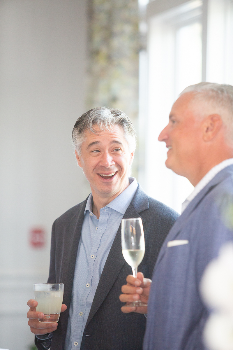 wedding guests laughing by North Carolina wedding photographer