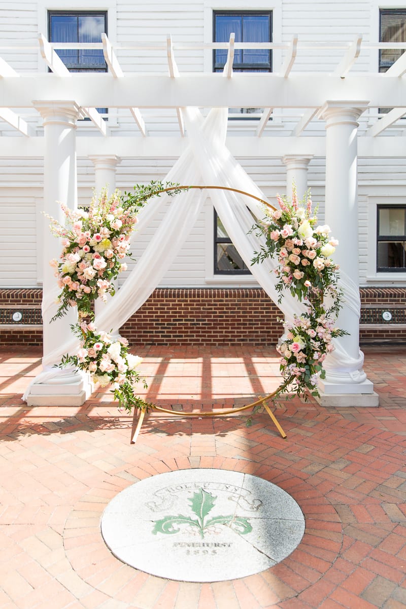 floral ceremony arch by Hillside Florist for a Pinehurst wedding at the Holly Inn
