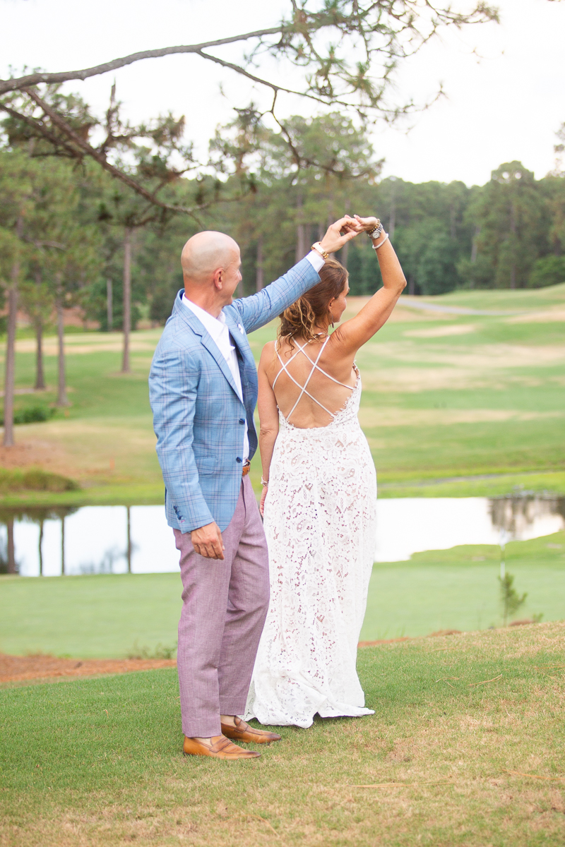 Couple dancing on golf course at Pinehurst wedding