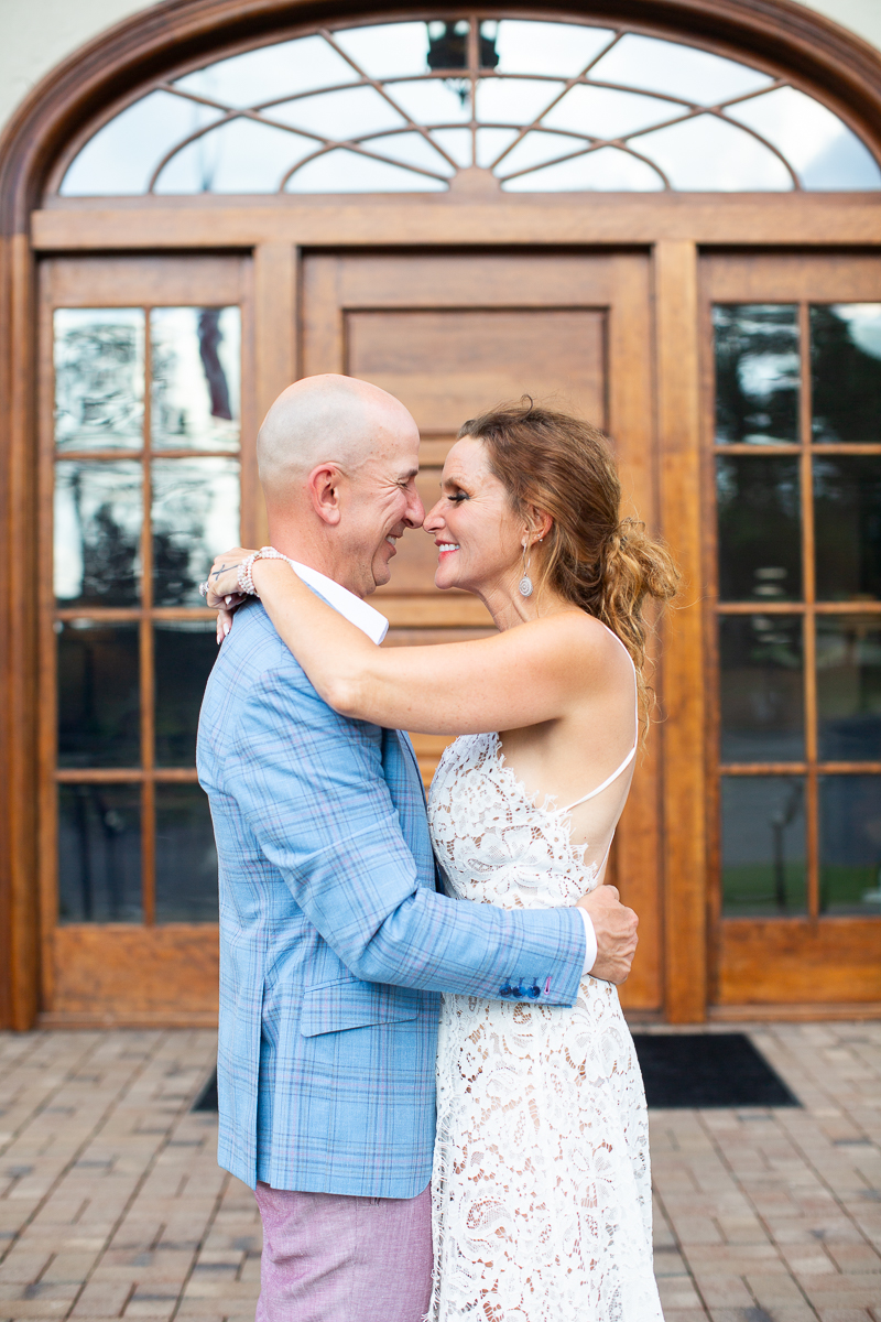 Bride and groom smiling by North Carolina wedding photographer