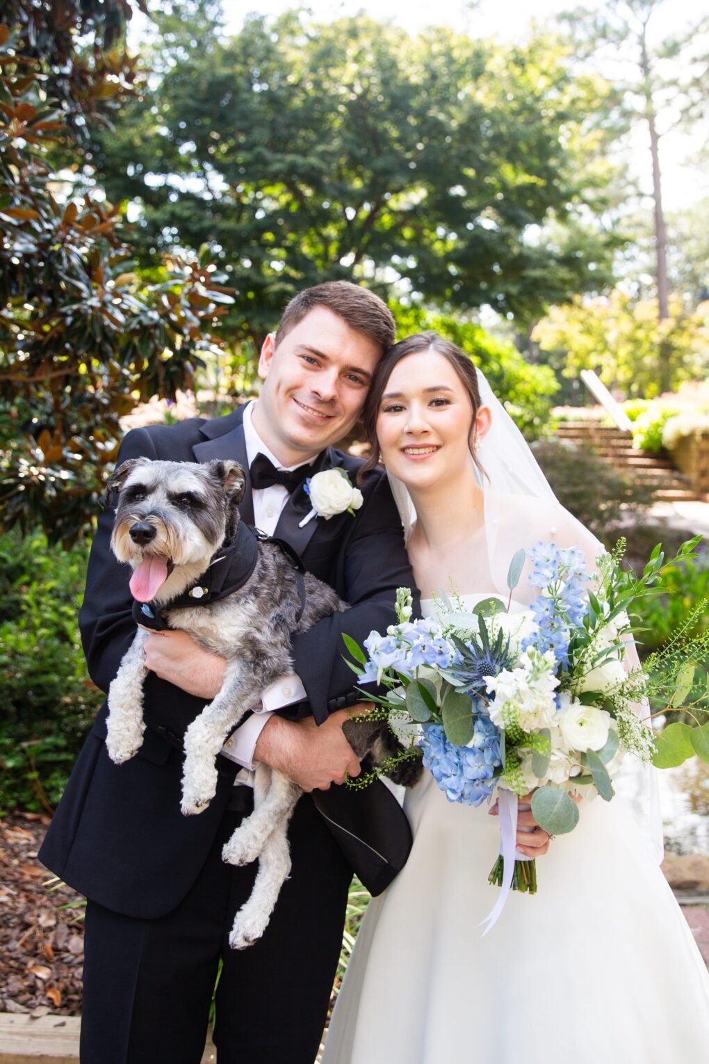 bride and groom with dog in front of koi pond at CCNC wedding