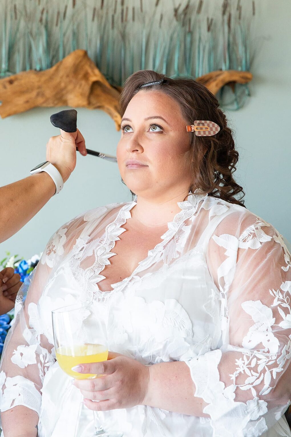 plus size bride getting ready in lace bridal robe
