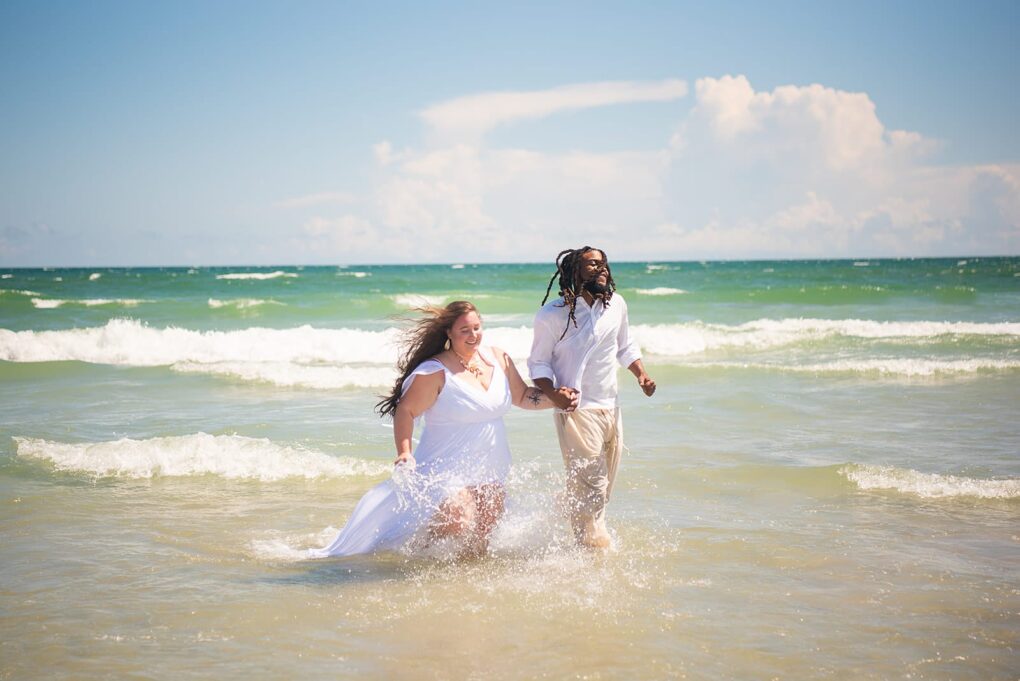 couple running on Wrightsville beach before NC beach wedding
