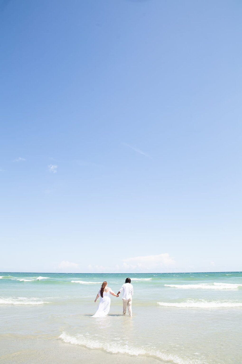 couple in surf nc beach wedding