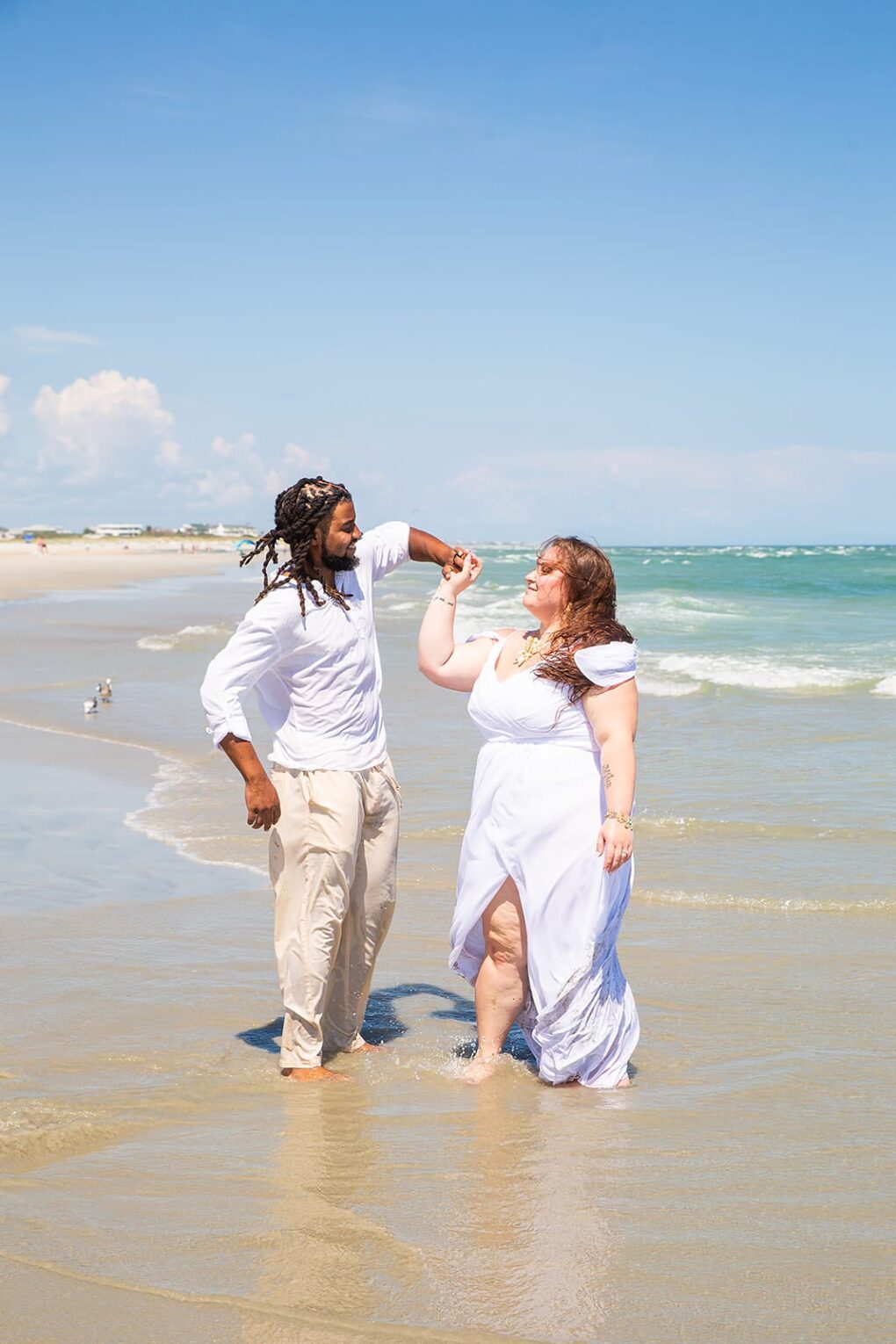 bride and groom dancing on beach