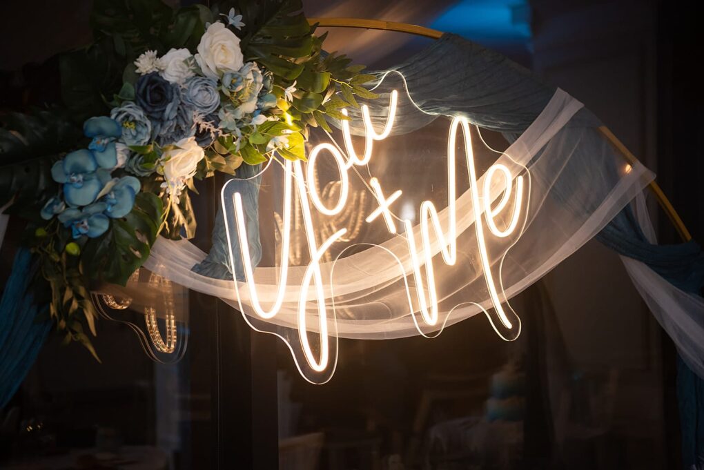 custom neon wedding sign that reads you and me in white neon