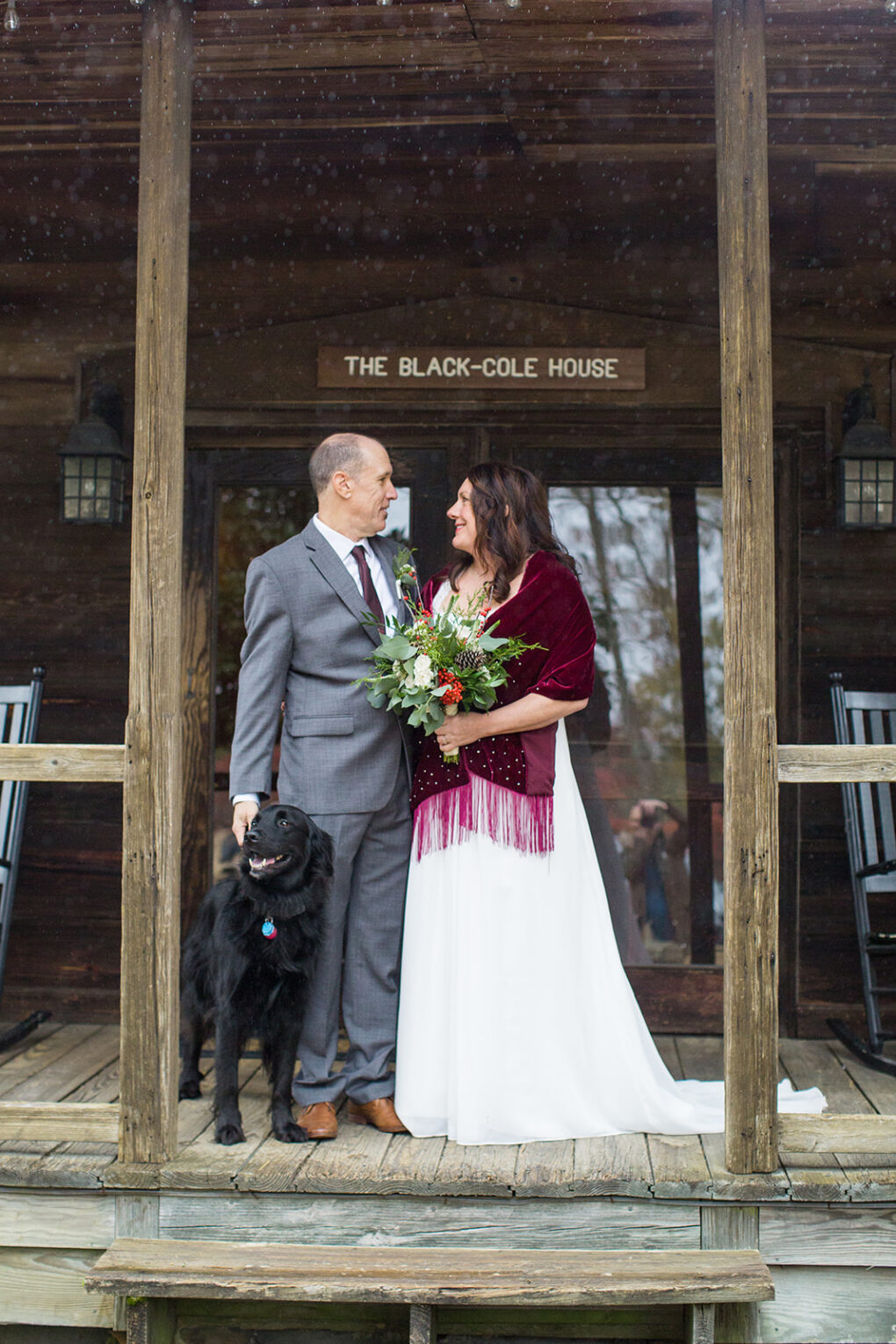 wedding couple with dog on front porch of the black-hole house at Rubicon Farm wedding