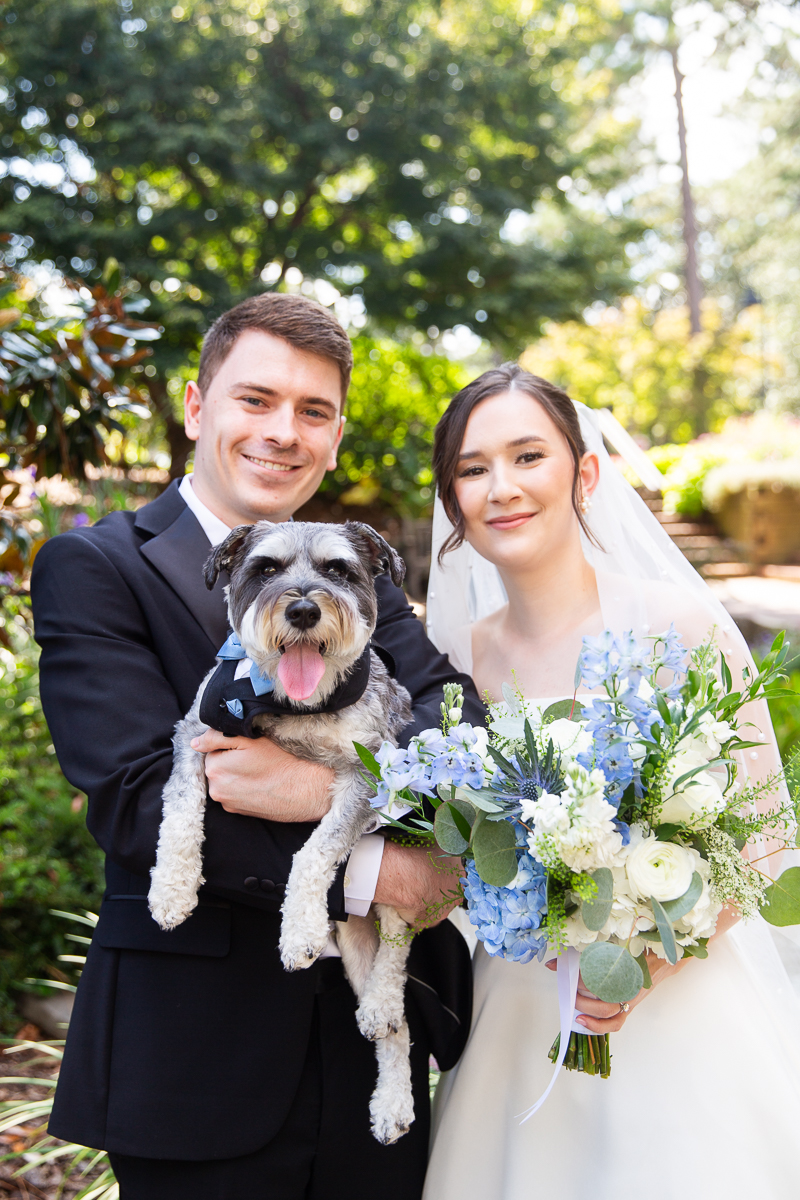 Bride and groom posing with their small dog during a Pinehurst wedding at the Country Club of North Carolina.