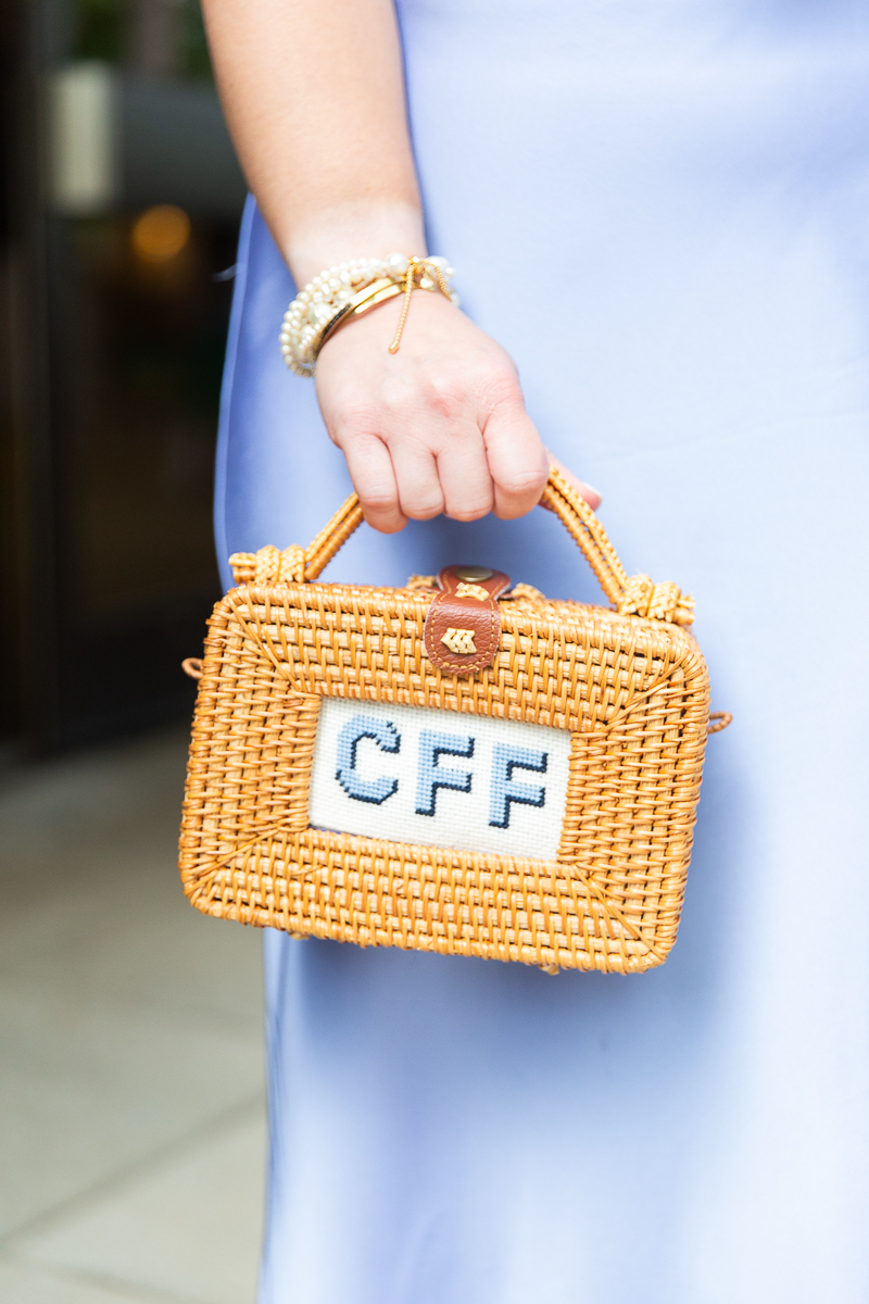 Bridesmaid holding a custom monogrammed handbag at a Pinehurst wedding.