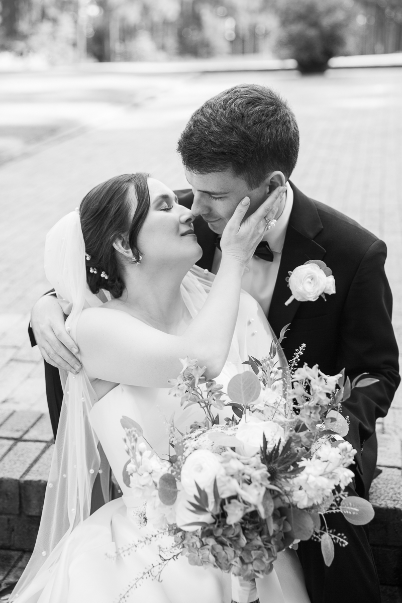 Black-and-white romantic wedding portrait of the couple embracing at the Country Club of North Carolina.