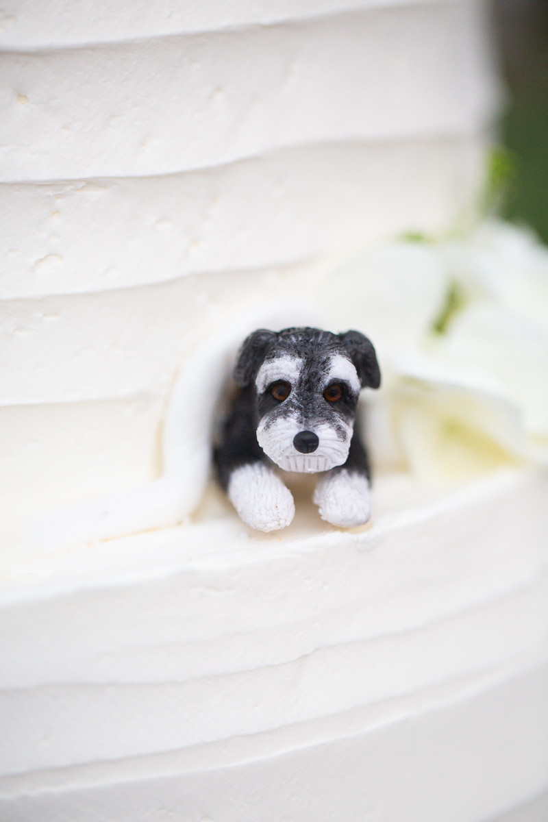 Custom wedding cake detail featuring a dog figurine.