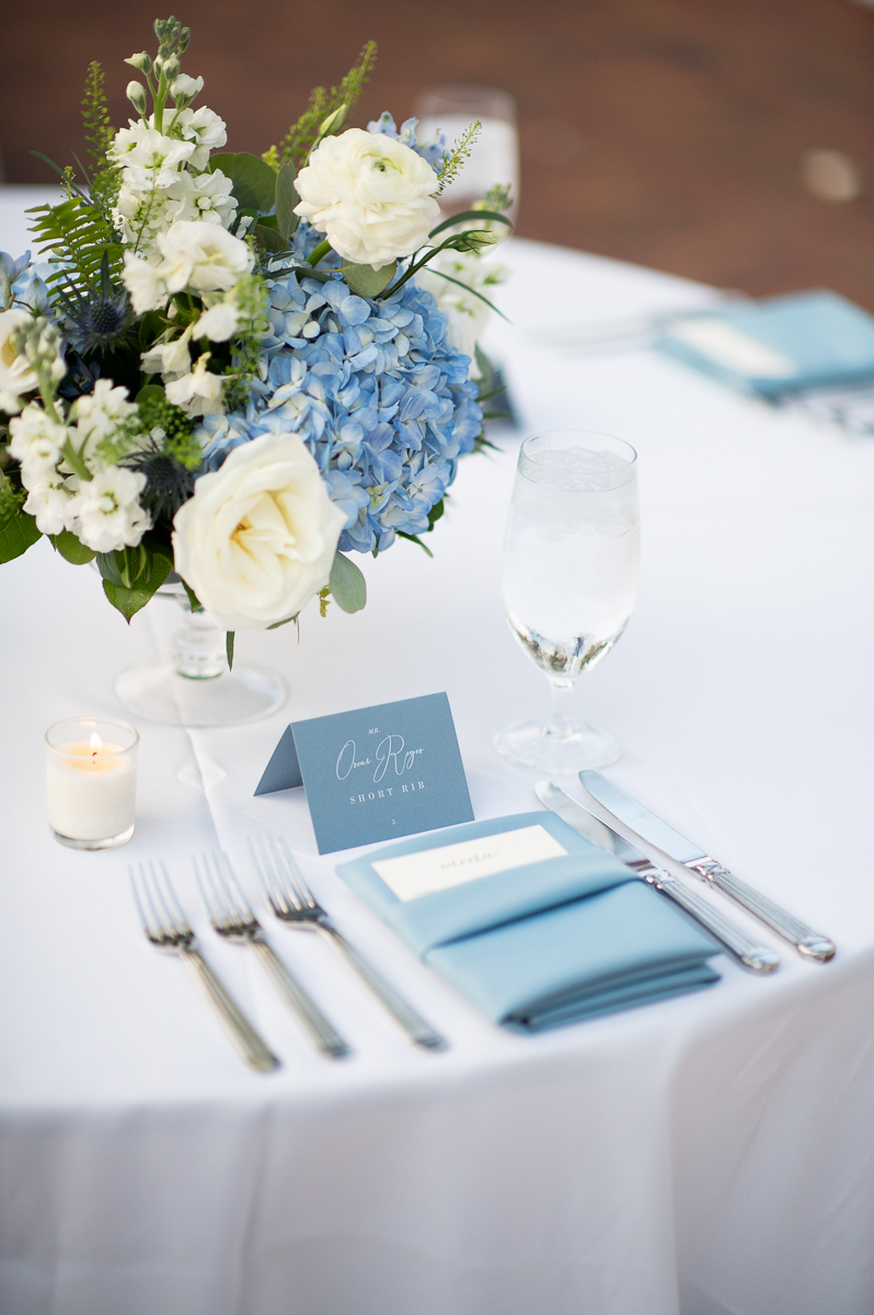 Elegant table setting with blue and white florals at a wedding reception in Pinehurst, NC.