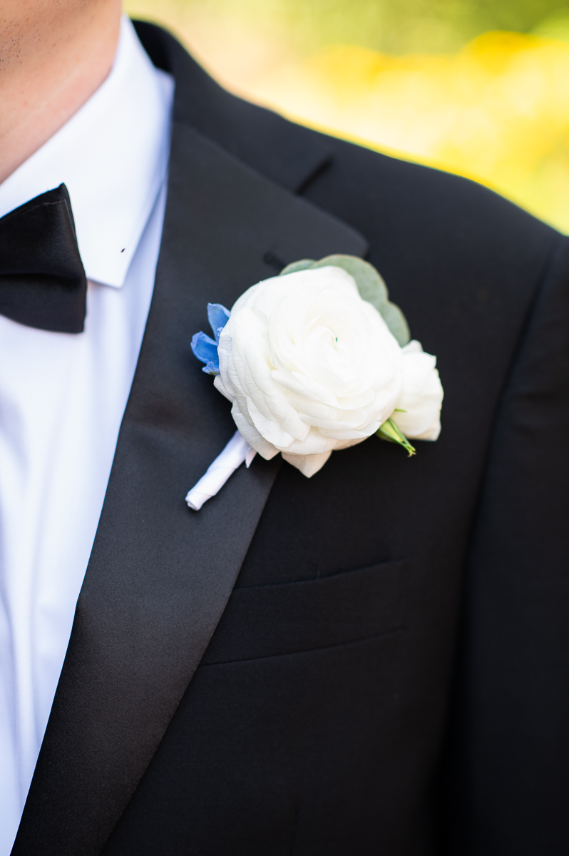 Close-up of the groom's boutonniere and tuxedo details at the Country Club of North Carolina.