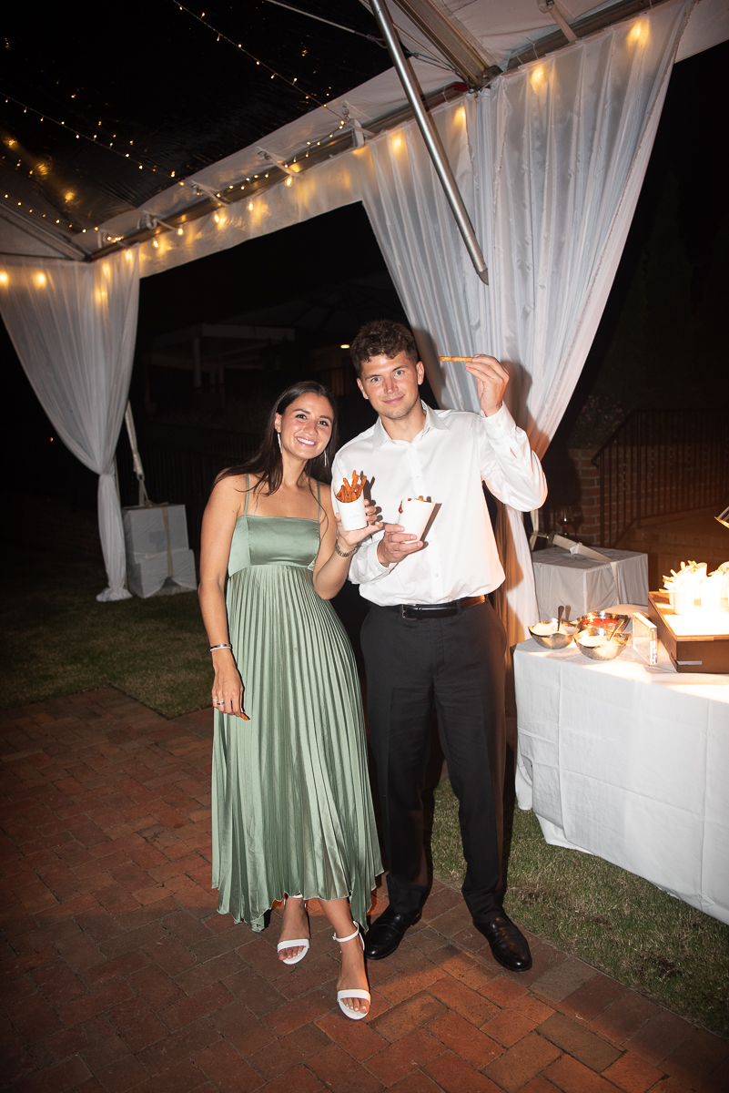 Bridesmaid and groomsman raising a toast during the reception at a Pinehurst wedding.