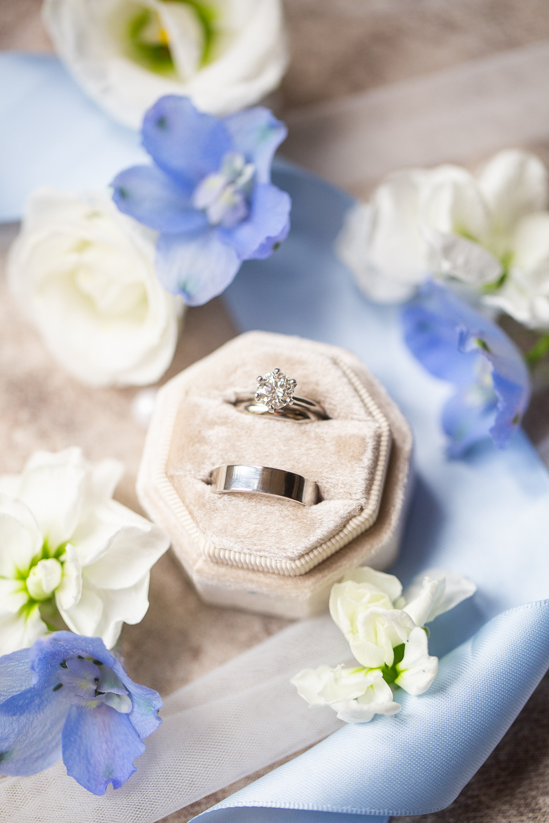 Velvet ring box with wedding bands and floral details