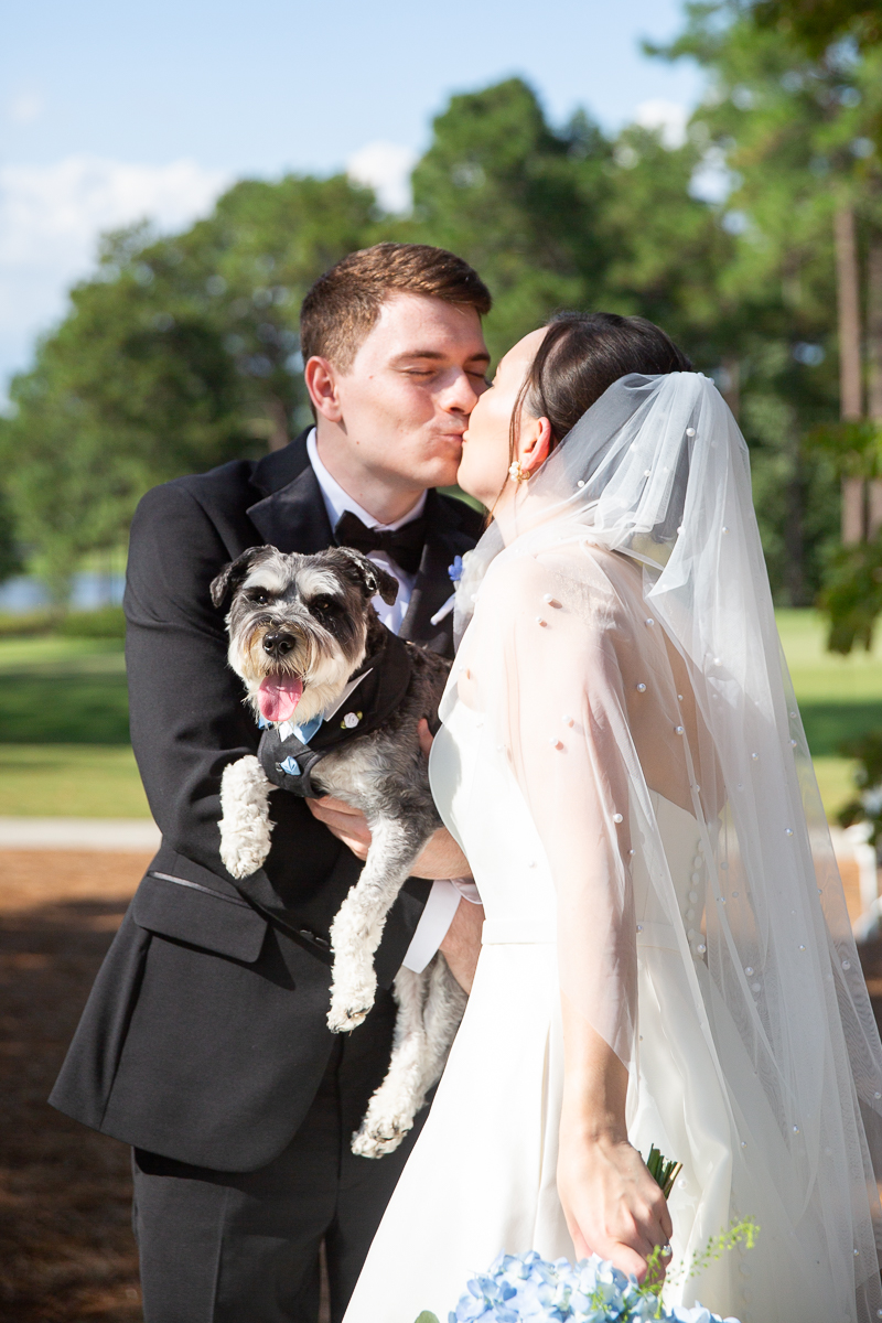 Wedding couple with their dog outdoors during a Pinehurst wedding at CCNC.